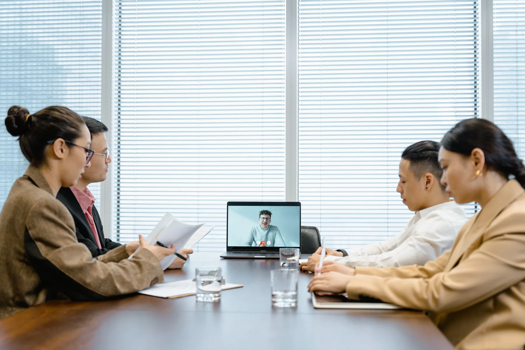 Professional team in a hybrid video meeting.